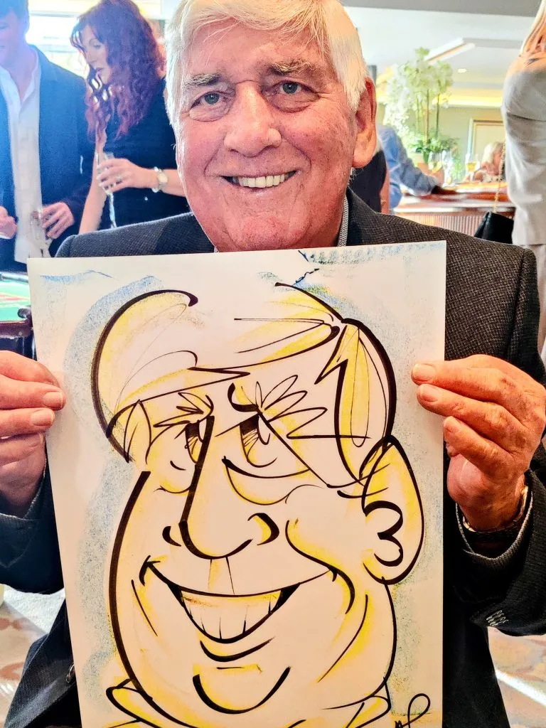 man holding a caricature